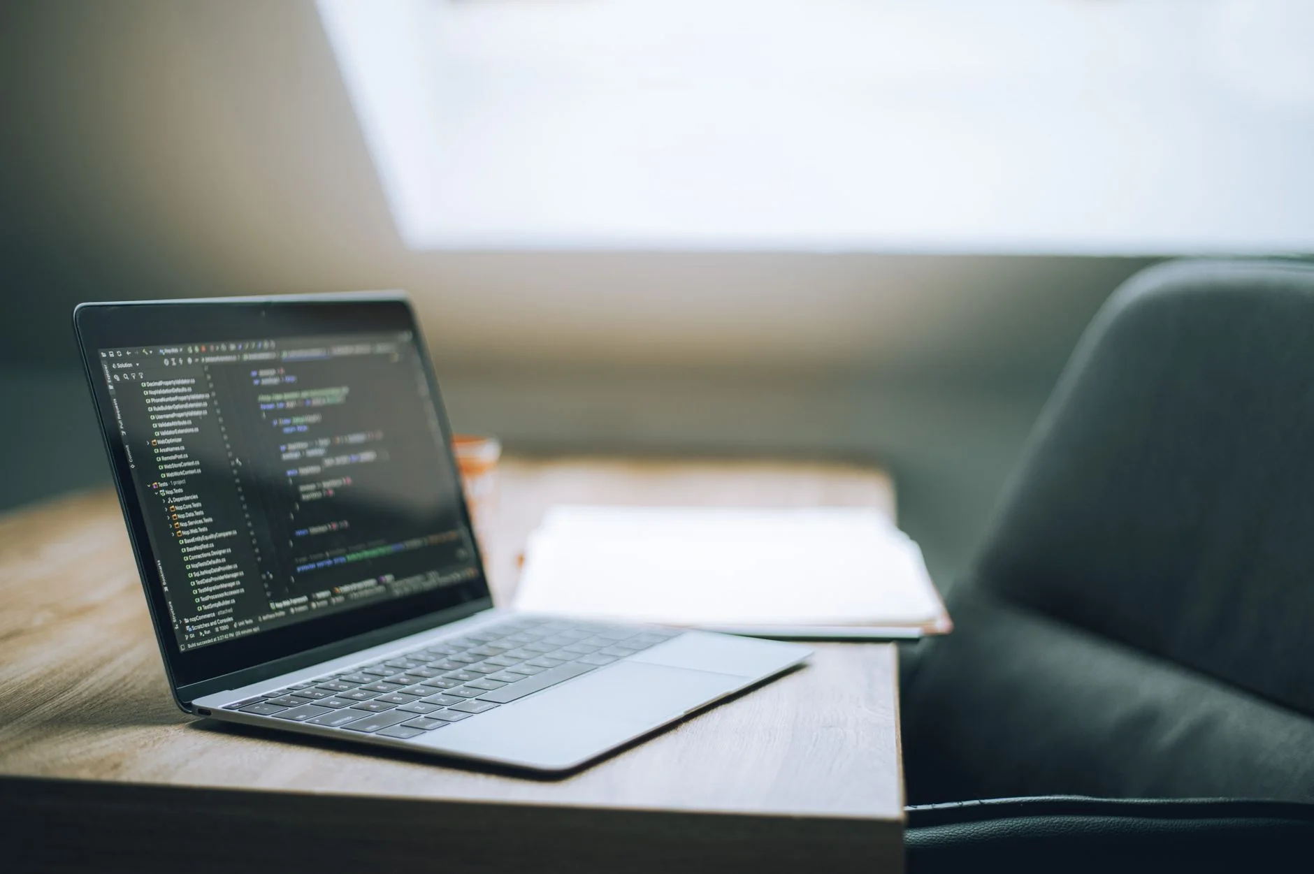 Laptop on desk showing code and deployment