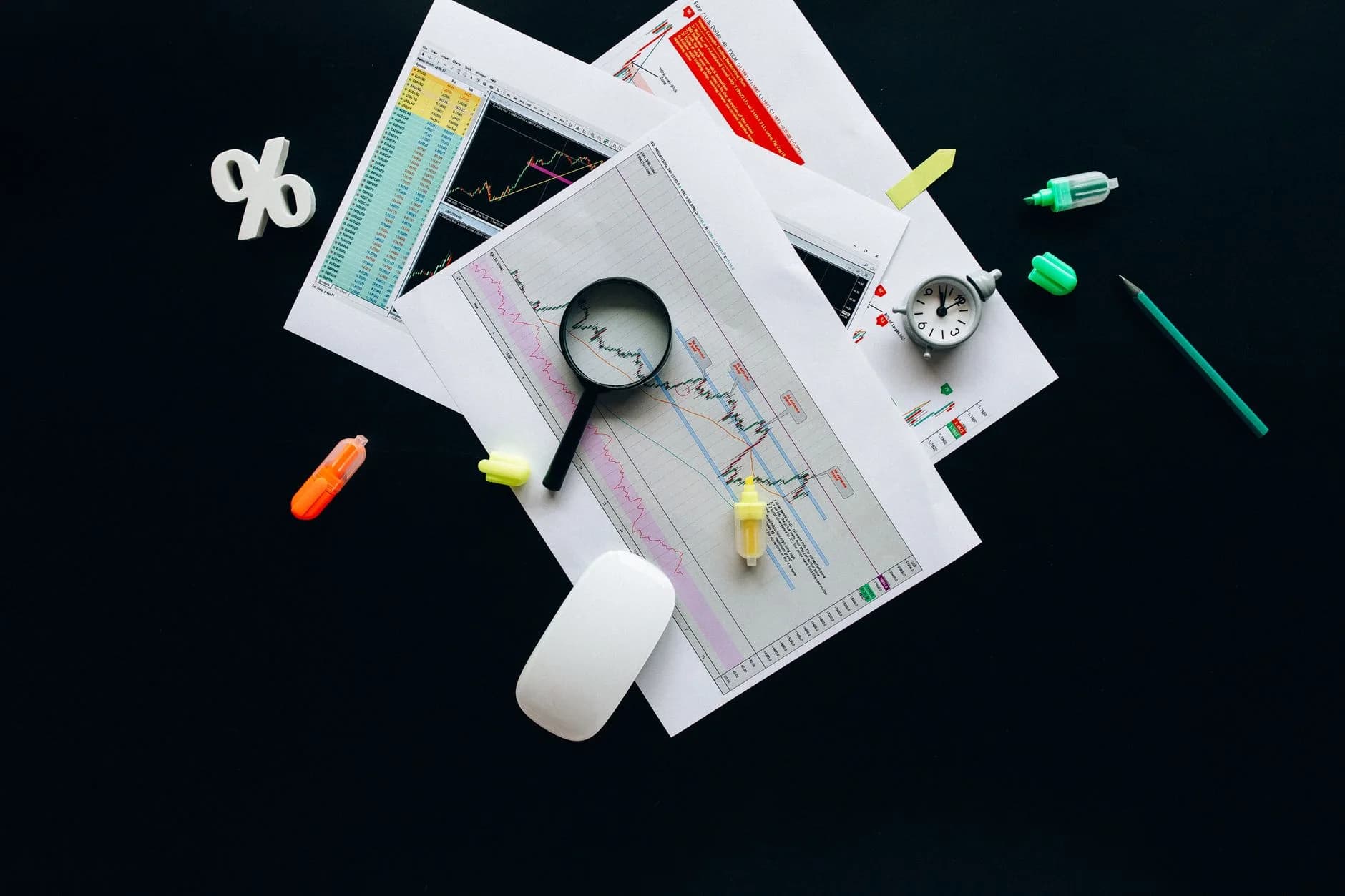 Overhead view of an office desk with a magnifying glass and documents