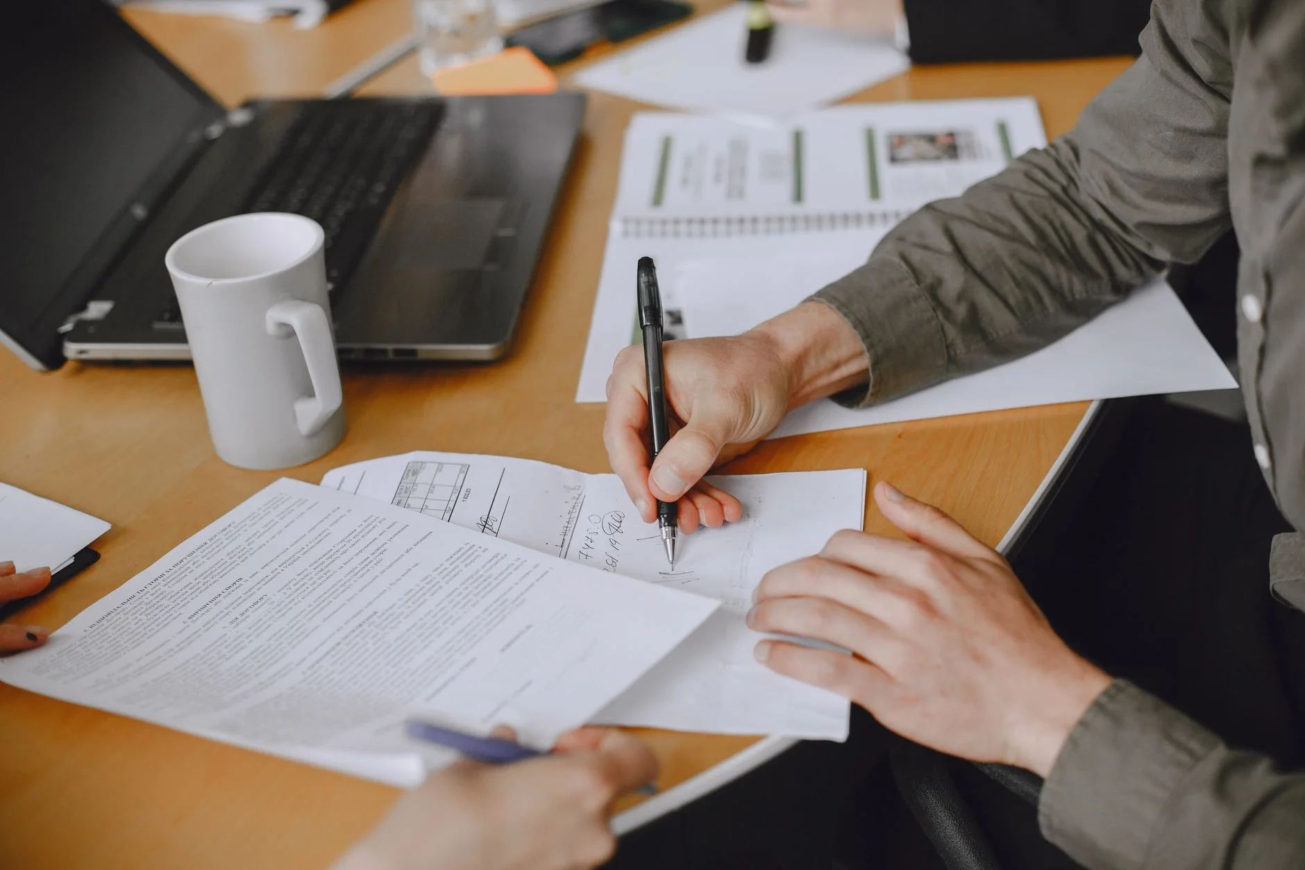 Close-up of signing documents at business meeting